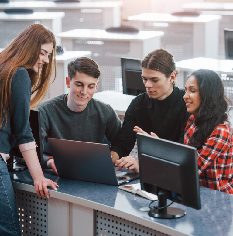 Active conversation. Group of young people in casual clothes working in the modern office.